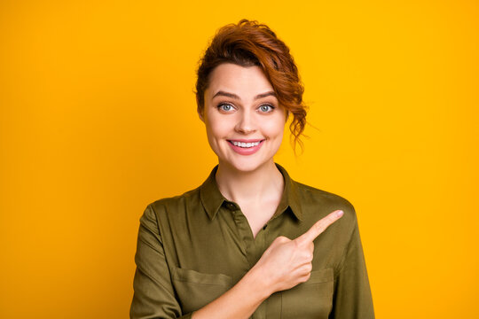 Close Up Photo Of Business Woman Pointing On Copy Space Near Her Shoulder Having Toothy Smile Isolated Over Vivid Shine Color Yellow Background