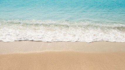 Fototapeta na wymiar wave of blue ocean on sandy beach. texture Background.