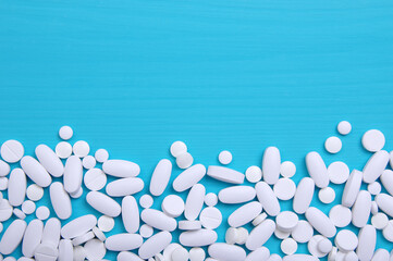 Heap of pills on blue
