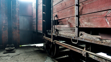 An old crumbling wagon made of boards standing at a railway station © RITHOR