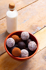 Protein balls with dates, almonds, oats, walnuts. Almond milk in jar, healthy breakfast