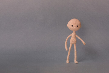A toy man on a gray background with copy space. Cute amigurumi. Presentation PowerPoint or Keynote....