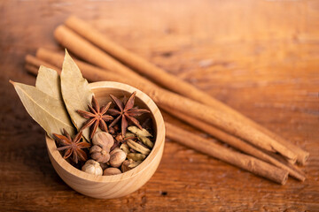 Spices and herbs ingredients for cooking Curry, Curry powder, clove, cardamom, cinnamon, caraway on wooden background.