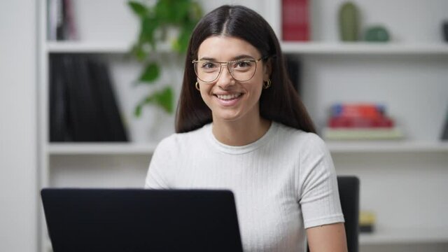 young girl works on the computer in her office