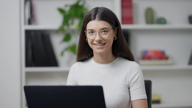 young girl works on the computer in her office