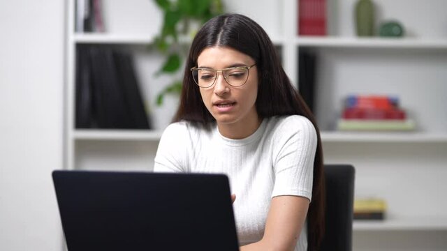 young girl works on the computer in her office