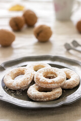 Sand dough biscuits, coffee and walnuts on a linen tablecloth. Rustic style.