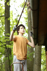 closeup photo of teenager boy cleaning roof from old leafs