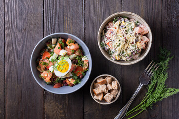 Salad with fresh vegetables  with red beans,  tomatoes,  dill, half egg,  toast Close up view
