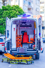 A stretcher stands in front of the ambulance 