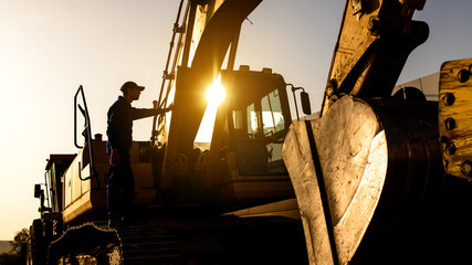 A contractor builder is sitting near bulldozer