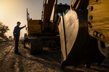 A contractor builder is sitting near bulldozer