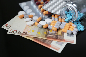 Pills and capsules on euro bills. Concept of health care, pharmaceutical business, drug prices in EU, pharmacy, medicine and economics