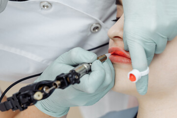 Woman having permanent makeup on lips in beauty salon