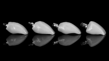 dental ceramic crowns arranged in a row for composition with reflection in black and white style