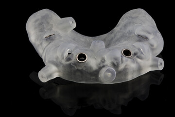 surgical template for dental implantation of four implants of the maxillary tant, shot on a black...