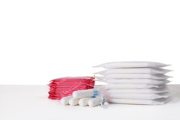 many menstrual sanitary pads and cotton tampons on white background. Feminine hygiene products