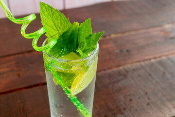 A glass of fresh Mojito. Lime and mint. On a wooden background
