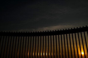 High fence at sunrise border concept