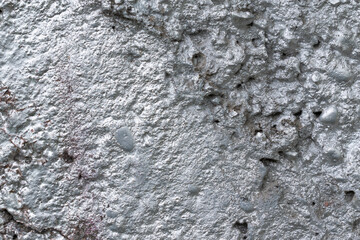 Concrete wall covered with silver paint. Stones, bumps, indentations. Color - Mischka, Hue Blue.