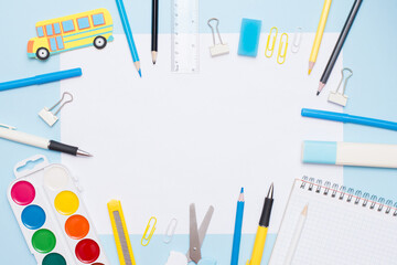 Education concept. Top view of school and office supplies on white and blue background with place for your text