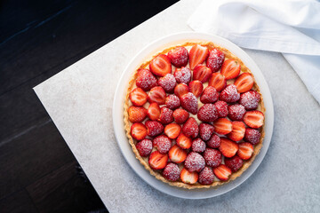 a dessert of a strawberry tart on a white plate