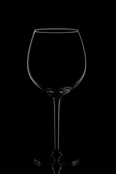 Empty glass of wine on a black background