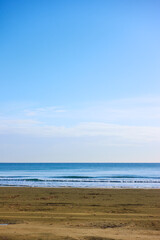 Sea, sandy beach and blue sky