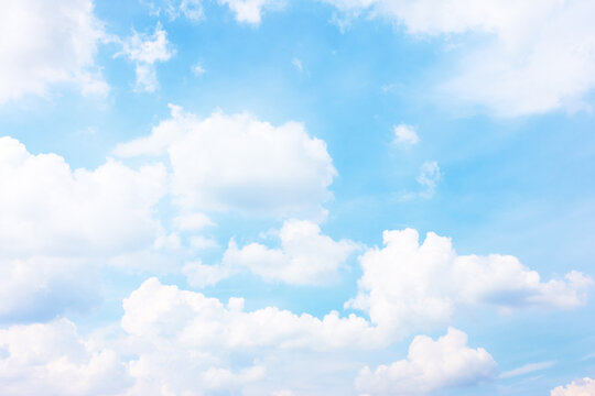 Pastel blue sky with white haep clouds