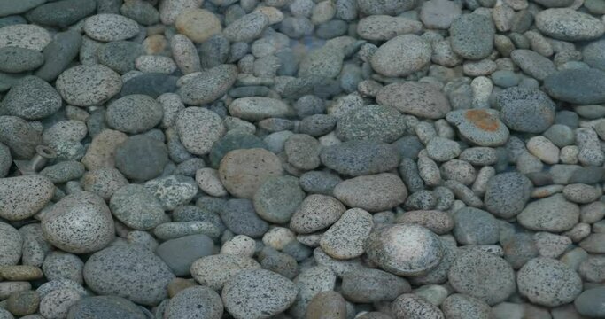 Pebble stone in water fountain