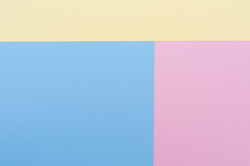 Yellow, blue and pastel pink background. Divided into three blocks. Backgrounds, textures.