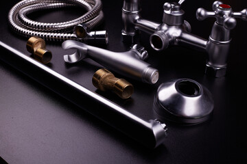 Plumbing tools on black background. Sanitary engineering