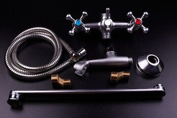 Plumbing tools on black background. Sanitary engineering