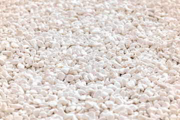 White pebbles in the rays of sunset