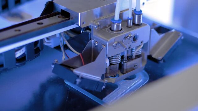 3D printer prints physical 3D model with plastic wire filament at modern technology exhibition, factory - close up. Additive technologies, science, manufacturing, futuristic concept