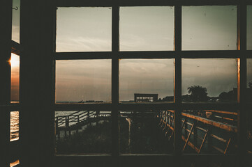 Fototapeta premium Evening sky view through the panoramic window of a beach house