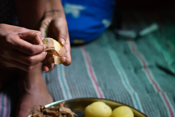 indian girl whittle (Chhilana) boiled potato in a plate, Indian food 