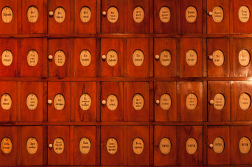 Wall of ancient pharmacy drawers with old inscriptions