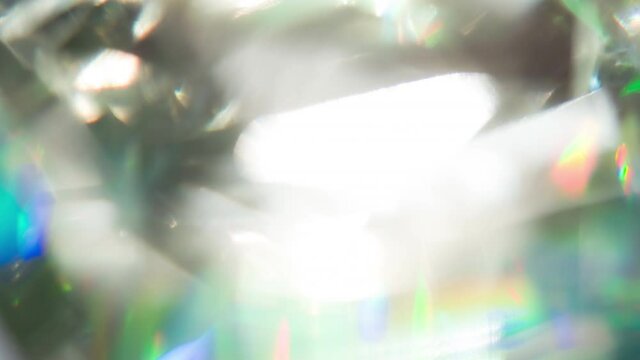 Multifaceted Prism With Iridescent Glare. Loop. Bright, iridescent reflections inside a faceted diamond. Facets create light diffraction and refraction
