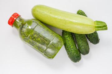 Bottle with green fresh raw smoothi from spinach, cucumber and zucchini