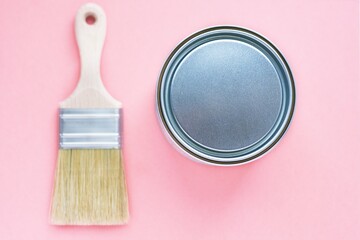 Paint brush with natural bristles for paint and metal can on colorful background. House renovation....