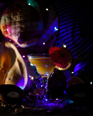 night beach party with orange cocktail glass with umbrella