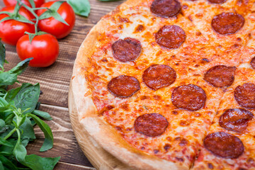 Pepperoni pizza on wooden background. Top view