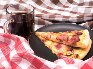 Two slice of pizza blanco. Comfortable home eating with glass of cola. Background of two dishcloth,...