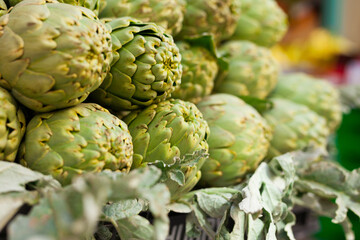 Fresh artichokes on market counter