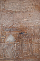 Hieroglyphic carvings on an ancient egyptian temple wall