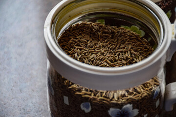 Picture of glass jars or cans used for store cumin seeds
