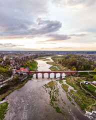Areal drone photo view of old brick bridge over river Venta.