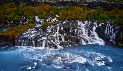 Incredibly beautiful Hraunfossar Waterfall. Lava waterfalls. waterfall flowing down from the lava fields on the canyon of the hvita river, Popular tourist attraction in Iceland. Iceland's clean water