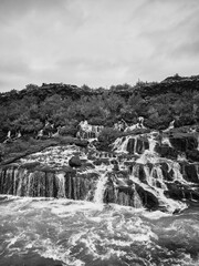 Incredibly beautiful Hraunfossar Waterfall. Lava waterfalls. waterfall flowing down from the lava fields on the canyon of the hvita river, Popular tourist attraction in Iceland. Iceland's clean water